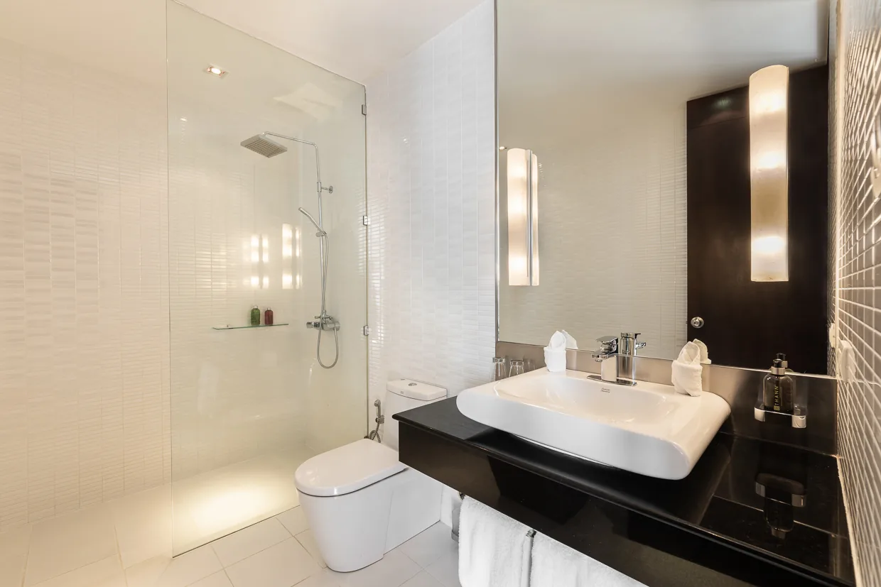A bathroom with a walk in rain shower