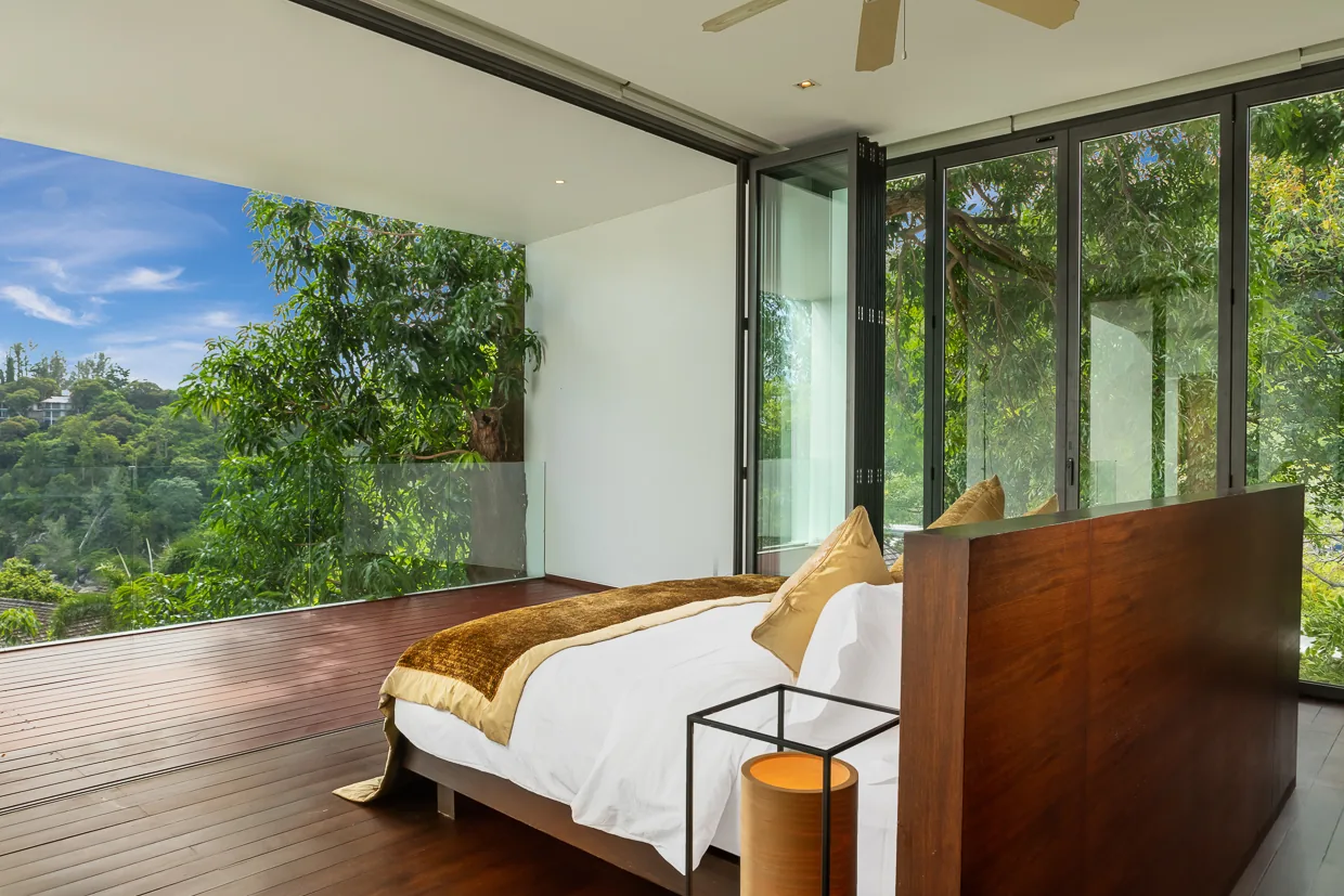 A bedroom looking into the tropical garden