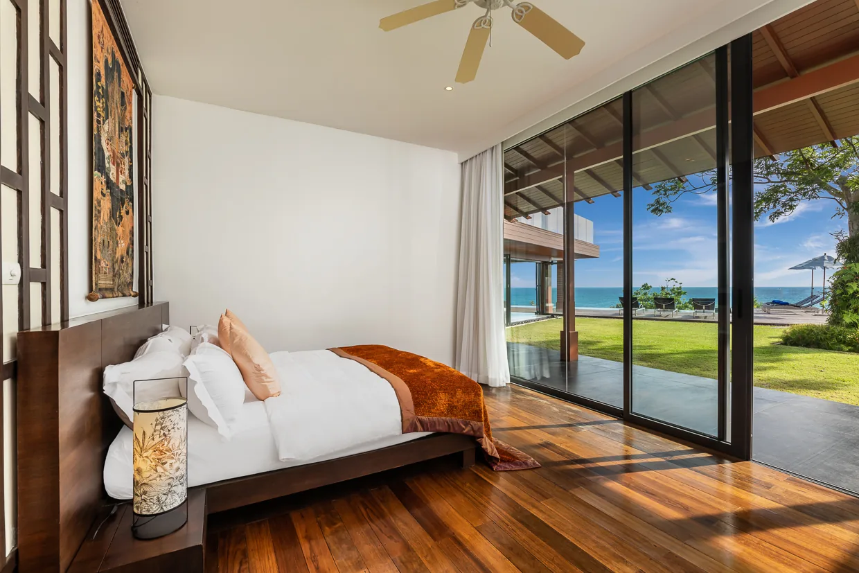 A bedroom looking across the lawn to the sea