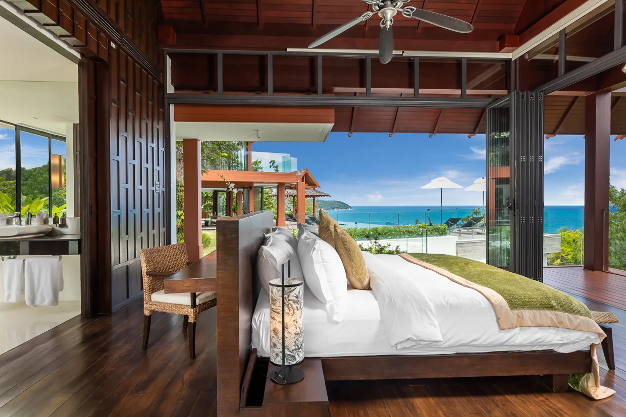 A bedroom looking out to the Andaman Sea through full height glass