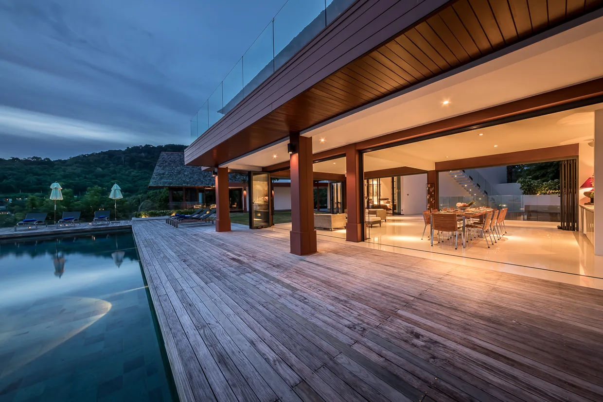 The pool deck and living pavilion at dusk
