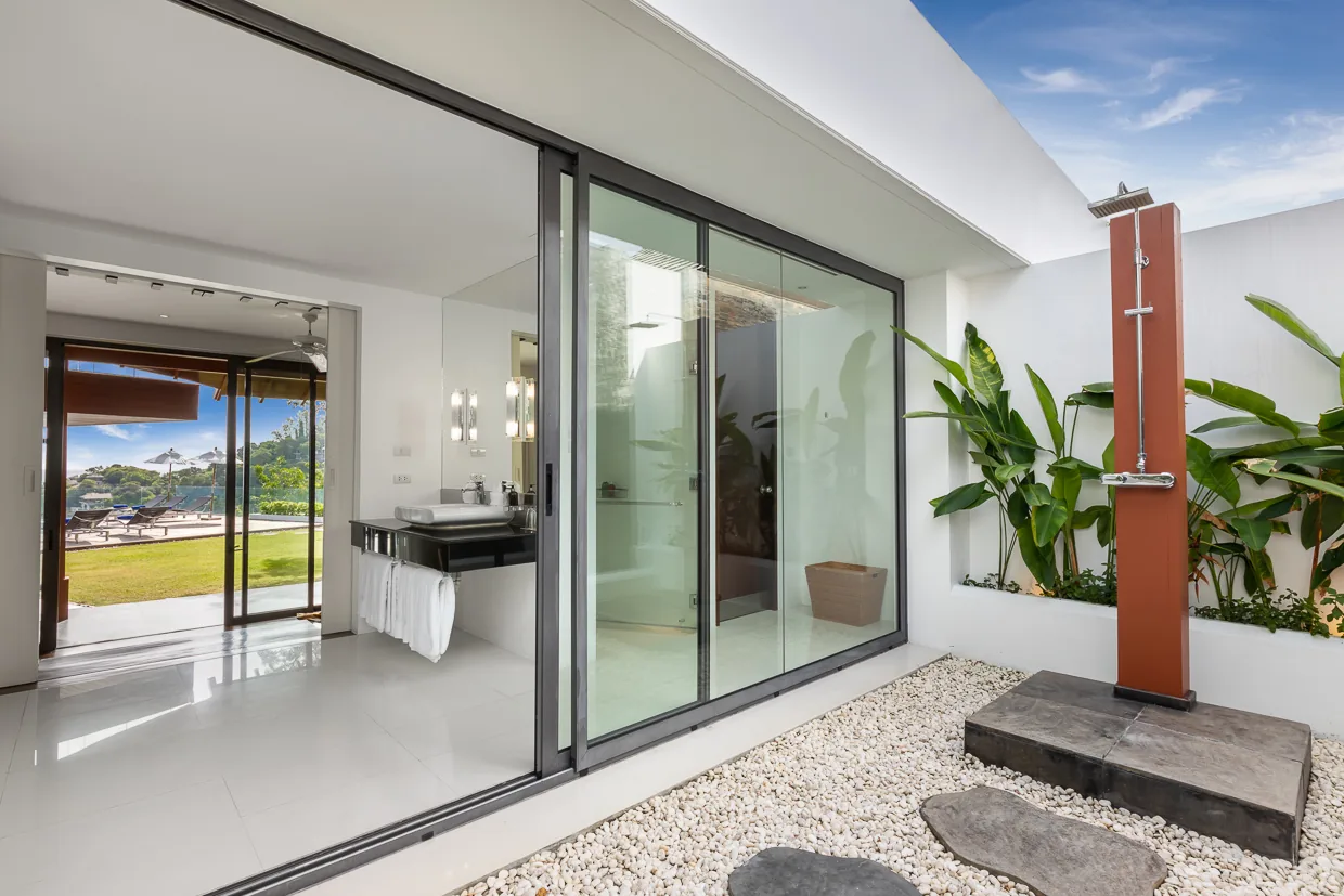 An ensuite bathroom opening to a private outdoor shower court