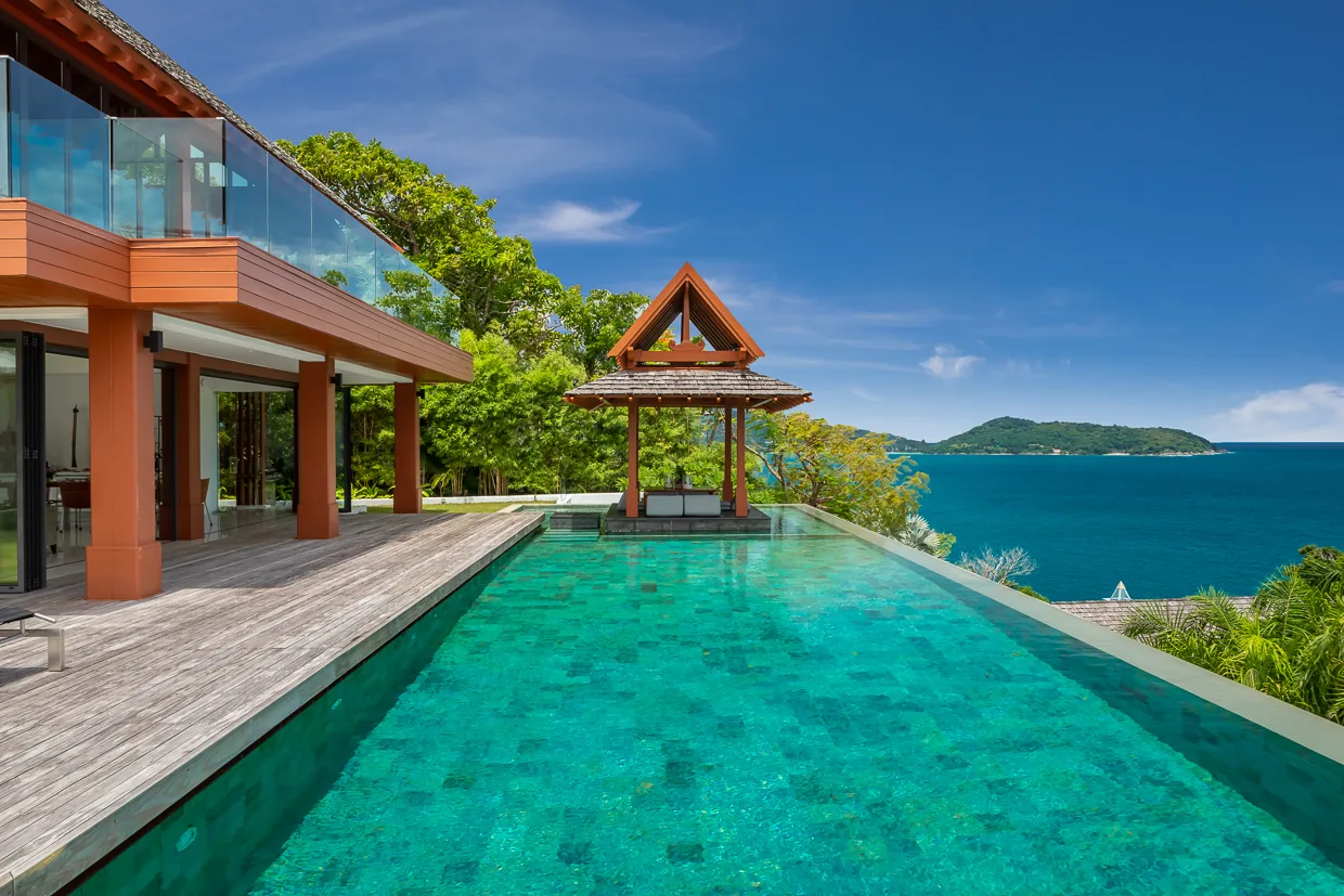 The 20 metre saltwater infinity pool in jade mosaic tile, with the sala at its end
