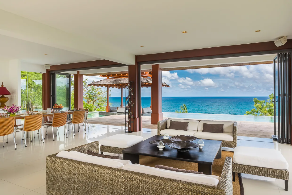 The living room with the ocean framed by open bifold doors