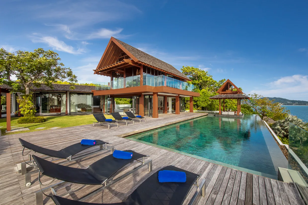 Loungers on the teak pool deck with the villa behind