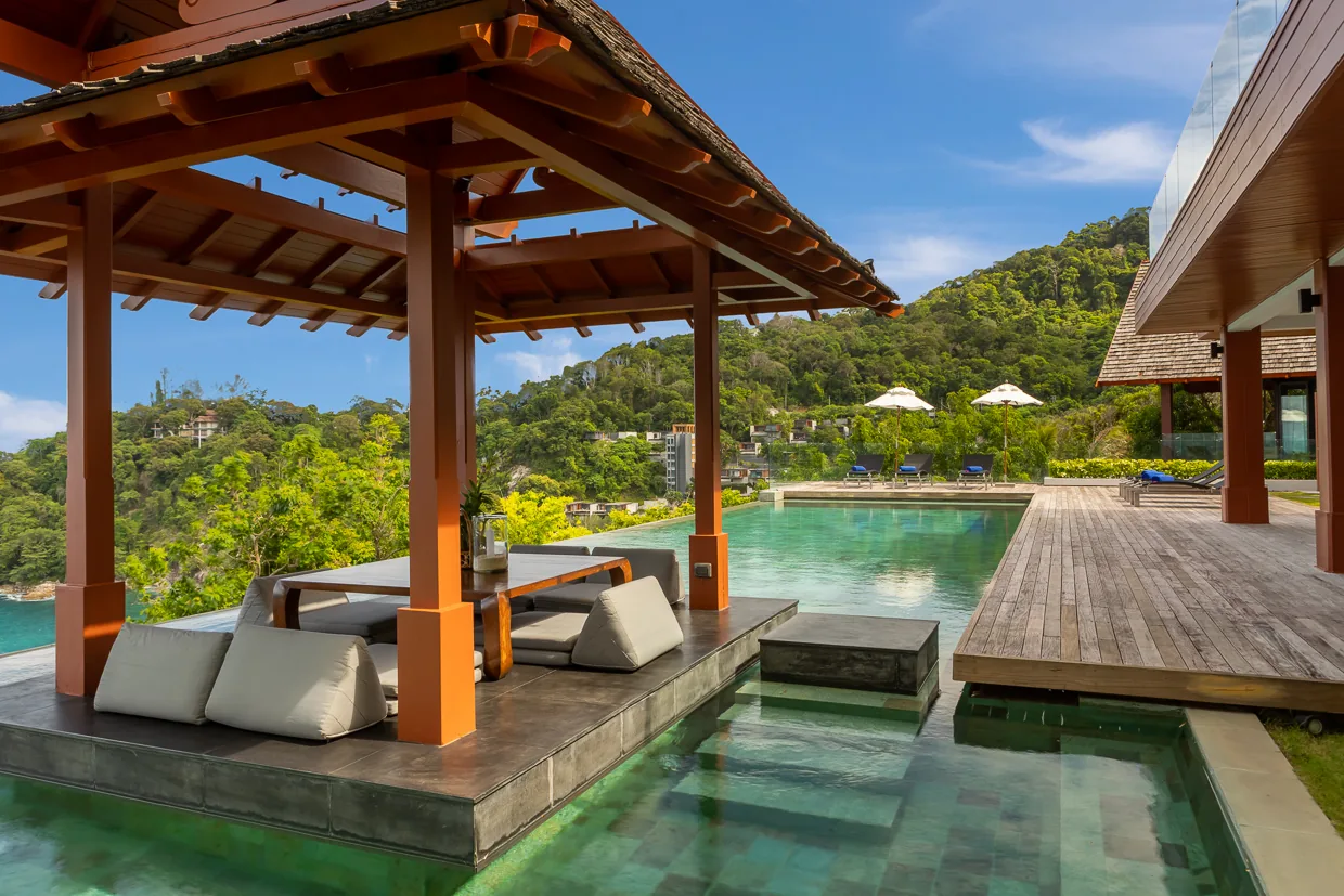 A sala daybed set over the water on vermilion posts
