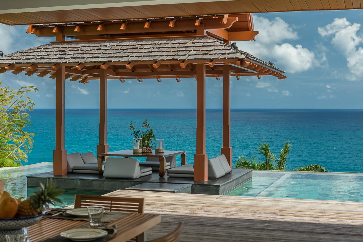 Dining in the sala at the pool's edge with the sea beyond