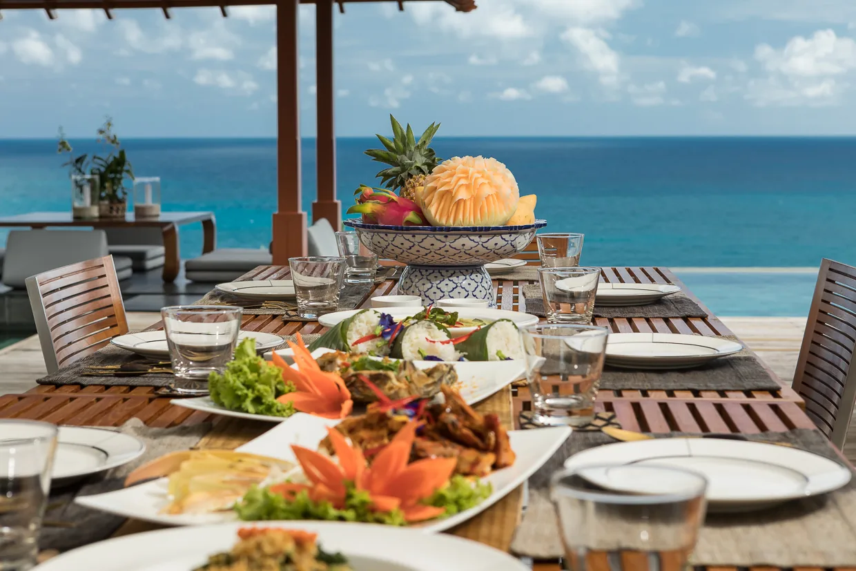 A Thai lunch laid on the outdoor table above the sea