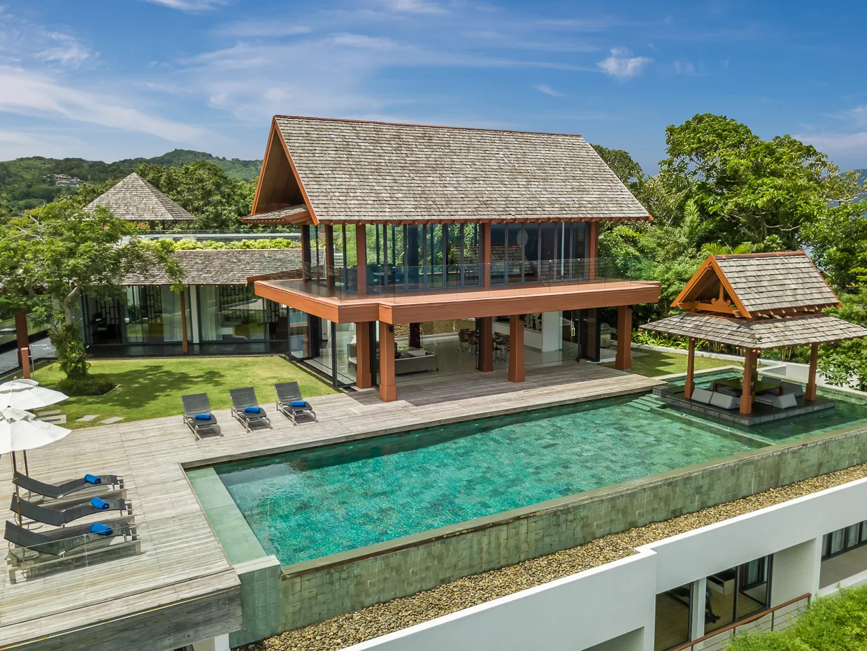 The pool terrace at Villa Baan Santisuk with its open air sala and loungers above the Andaman Sea