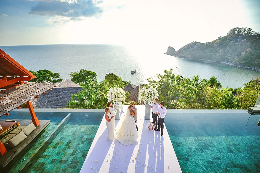 A wedding ceremony on the pool deck above the bay